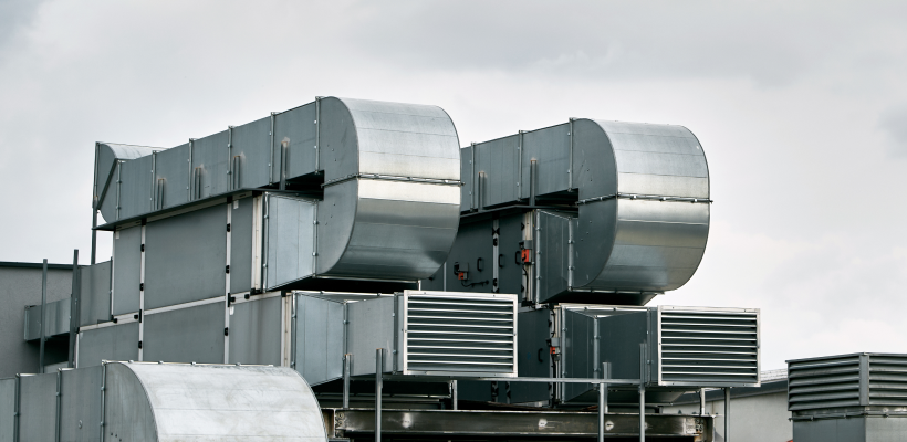 Large commercial rooftop HVAC ventilation ductwork and air handling equipment servicing a building, illustrating professional AC service Saskatoon by ONE Mechanical.